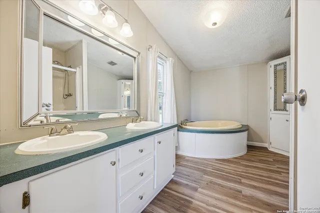 a bathroom with a granite countertop sink a toilet a mirror and vanity