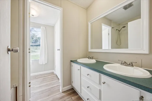 a bathroom with a granite countertop sink mirror and double