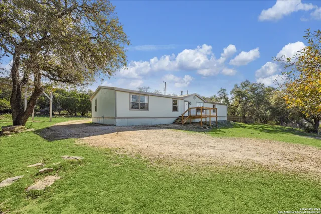 a front view of house with yard and trees