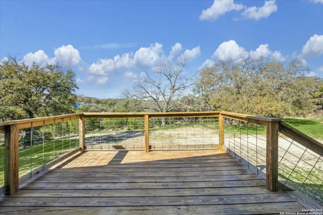 a view of a balcony with wooden floor