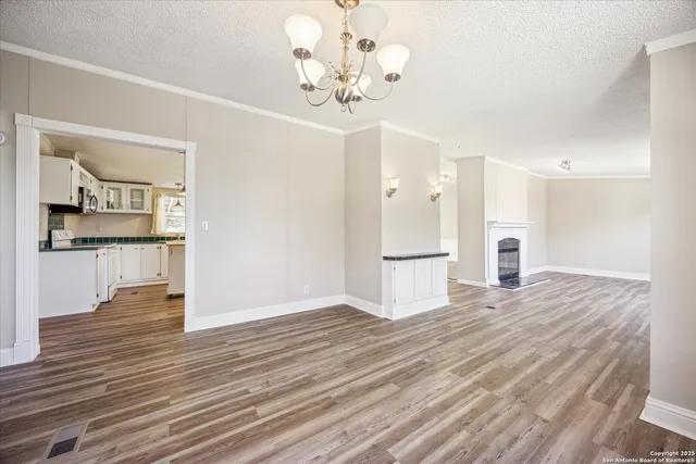 a view of a kitchen with wooden floor and a kitchen