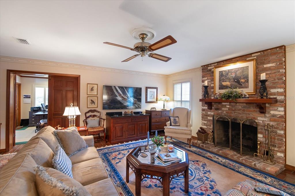 1506 South Sheridan Forest Drive Tampa, FL 33629 - Photo 15 of 41 a living room with furniture a fireplace and a flat screen tv