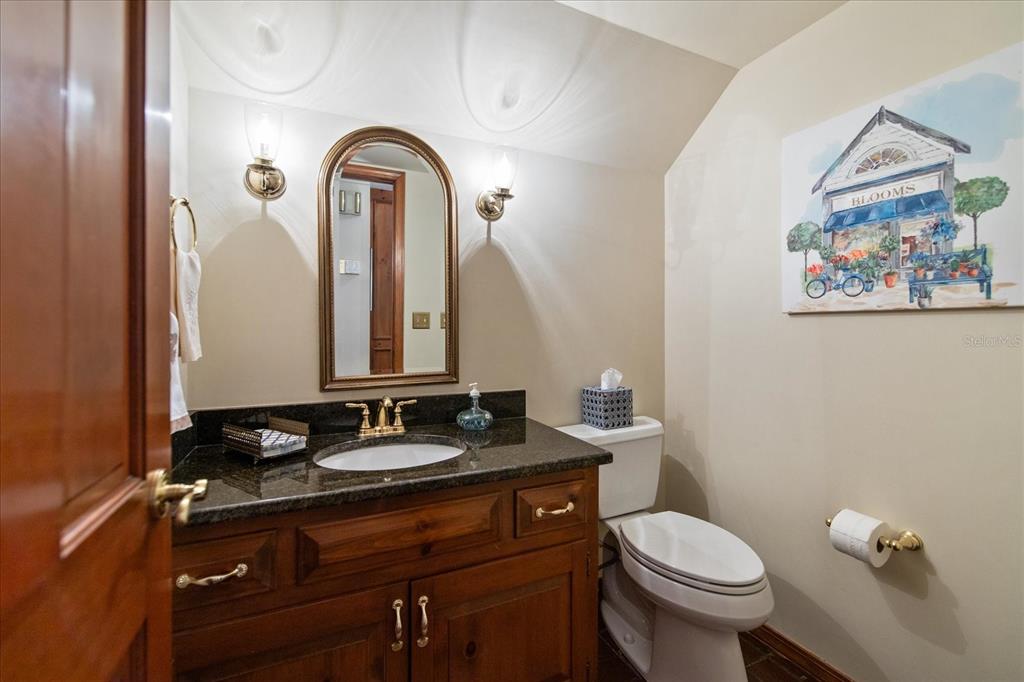1506 South Sheridan Forest Drive Tampa, FL 33629 - Photo 17 of 41 a bathroom with a granite countertop toilet a sink and a mirror