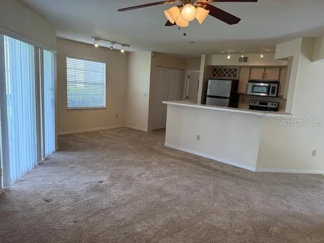 a view of kitchen with refrigerator stove microwave and cabinets