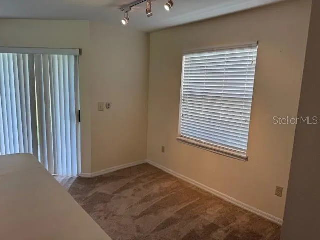 a view of a livingroom with a chandelier fan and a dresser