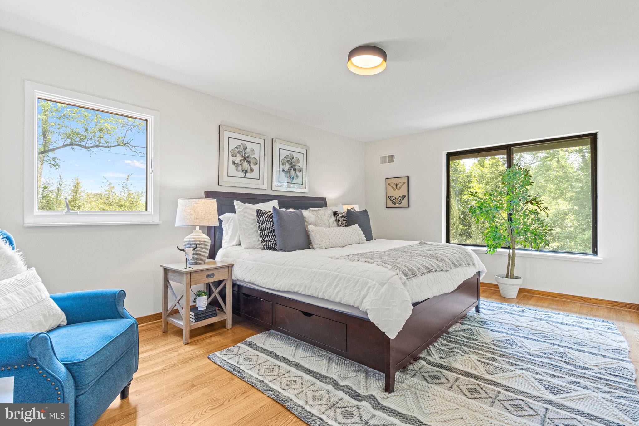 9712 Eldwick Way Potomac, MD 20854 - Photo 23 of 63 a spacious bedroom with a bed and a couch