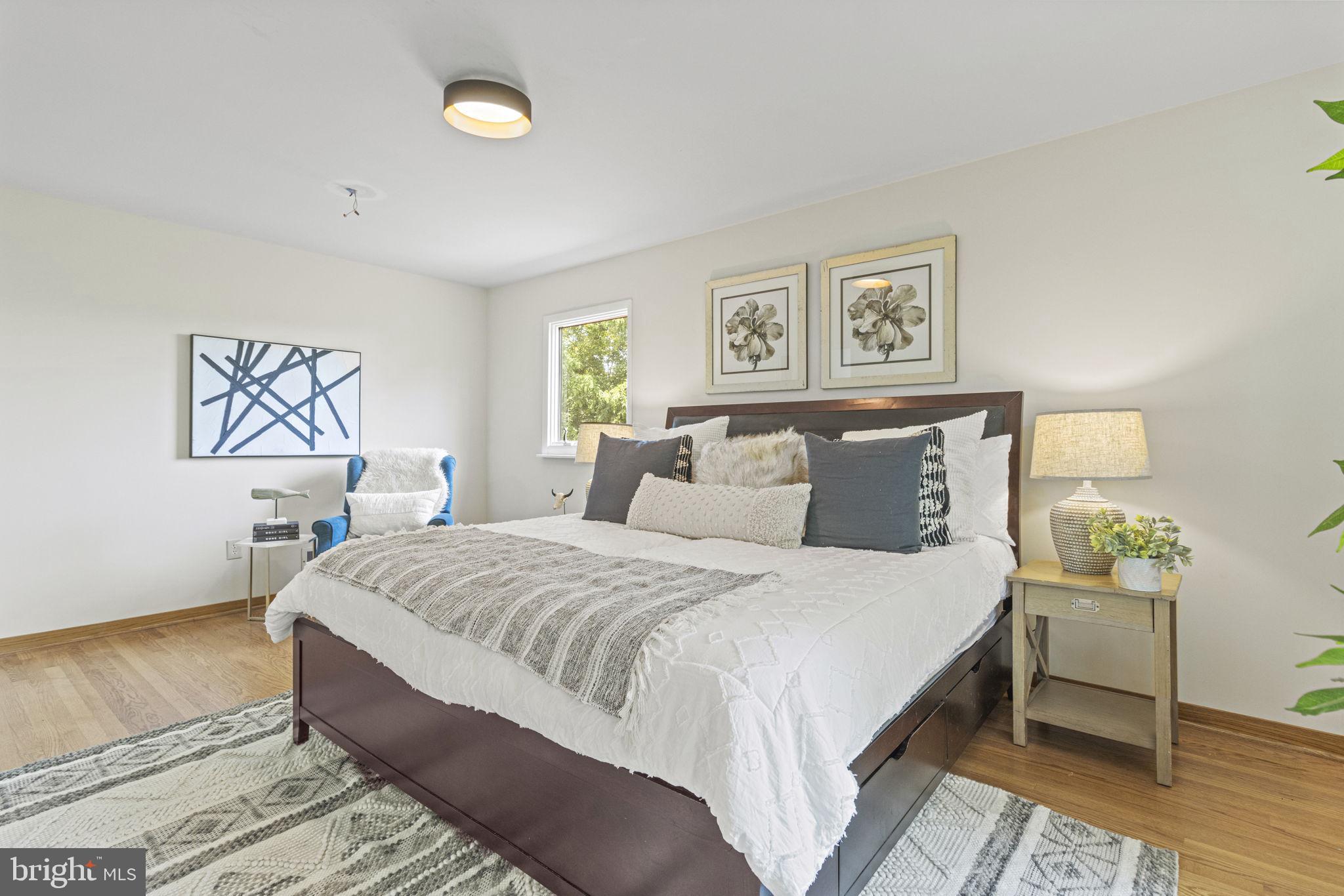 9712 Eldwick Way Potomac, MD 20854 - Photo 24 of 63 a bedroom with a bed and a night stand