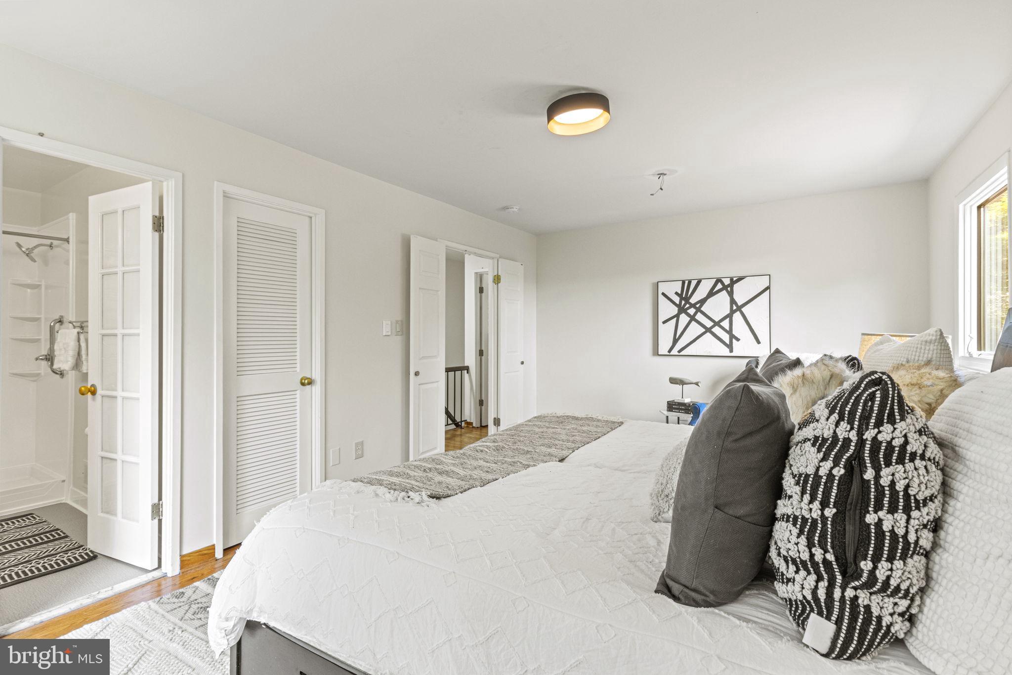 9712 Eldwick Way Potomac, MD 20854 - Photo 25 of 63 a bedroom with a bed and wooden floor