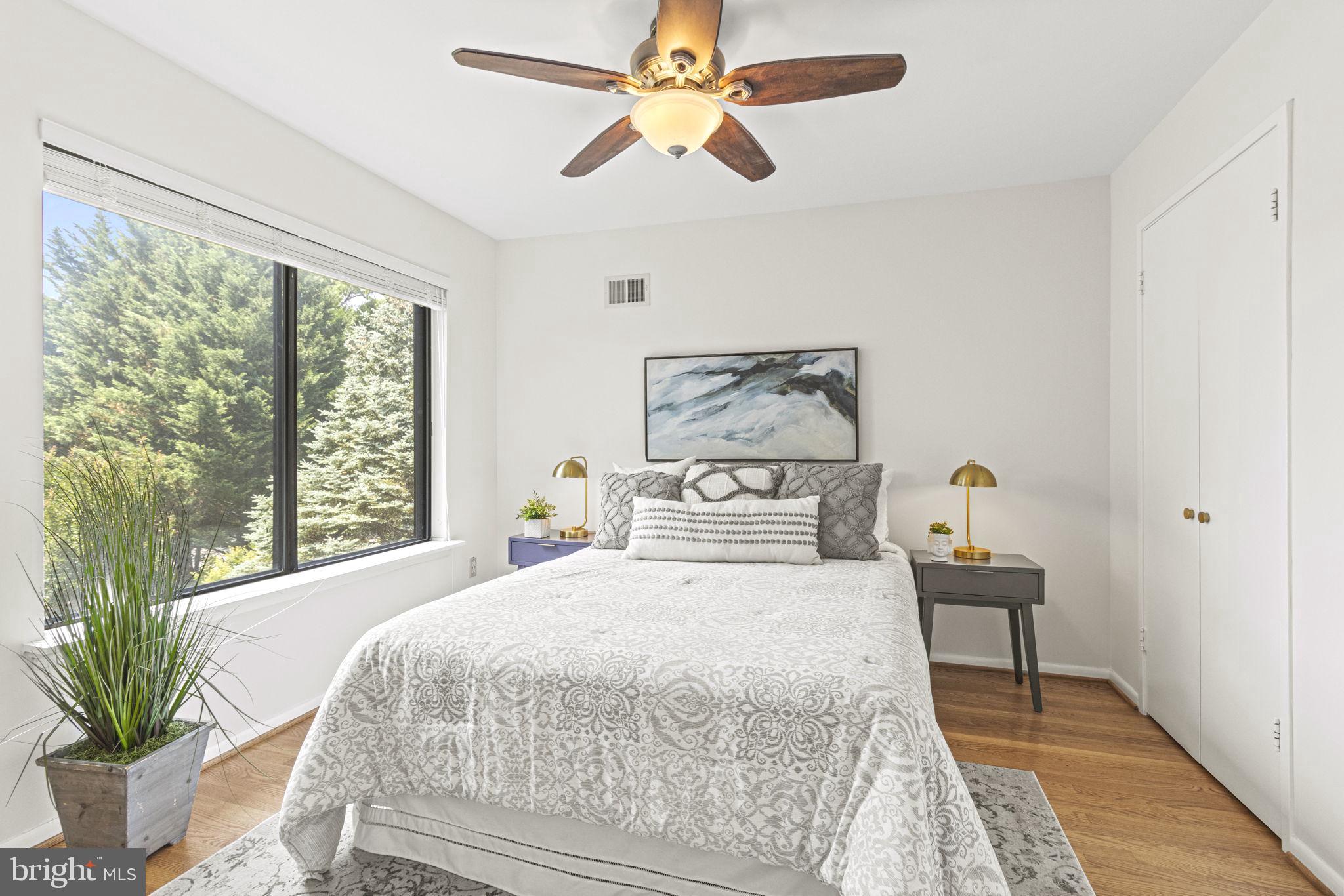 9712 Eldwick Way Potomac, MD 20854 - Photo 27 of 63 a bedroom with a large bed and a chandelier