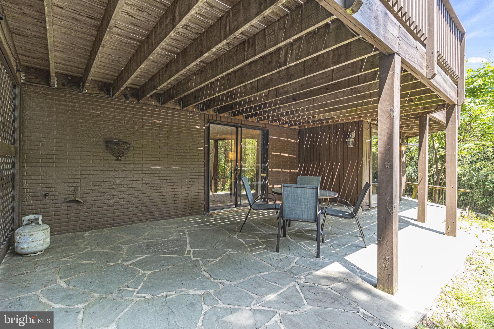 9712 Eldwick Way Potomac, MD 20854 - Photo 43 of 63 a view of a patio with table and chairs and wooden floor