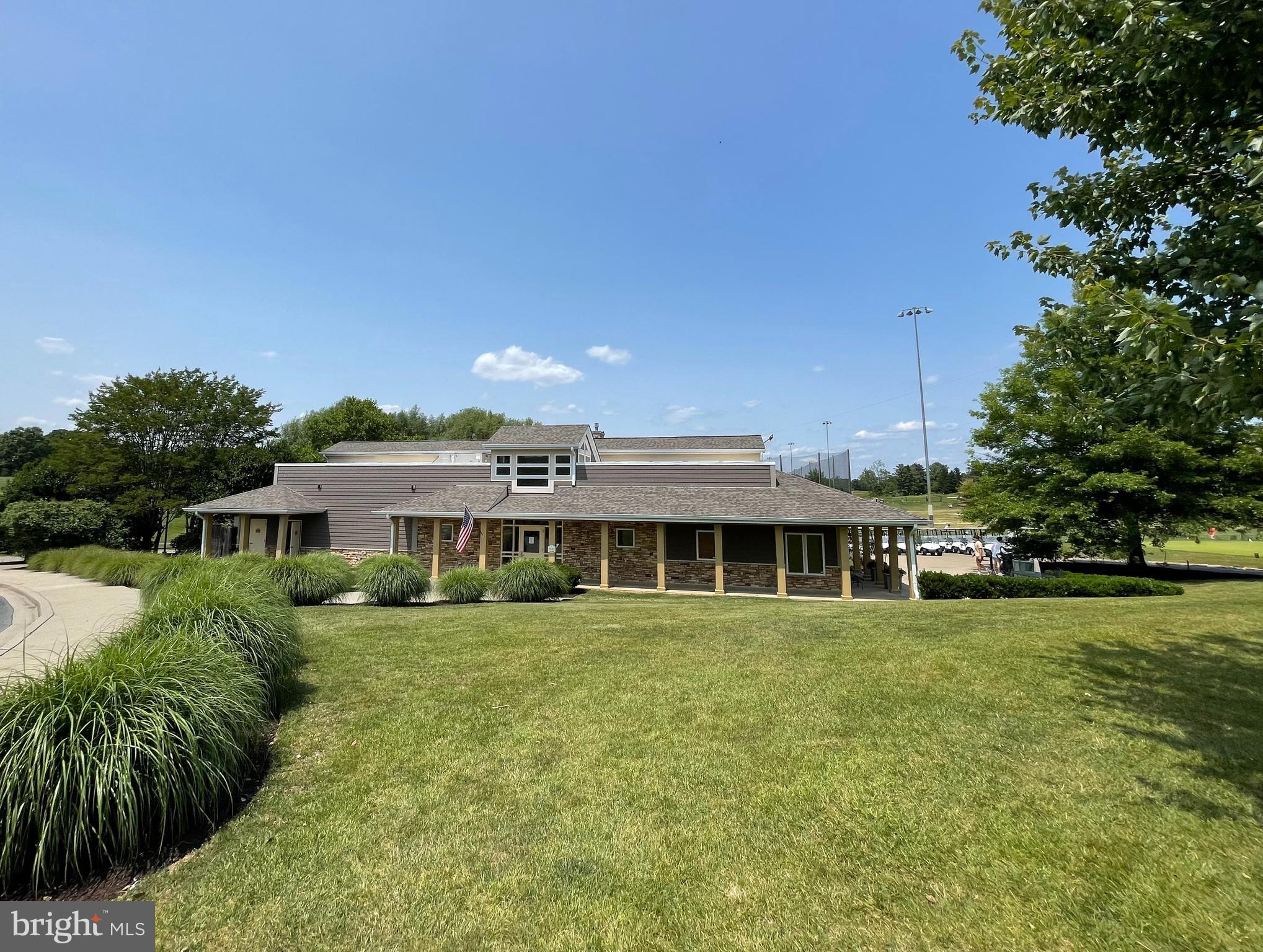 9712 Eldwick Way Potomac, MD 20854 - Photo 49 of 63 a front view of a house with a garden