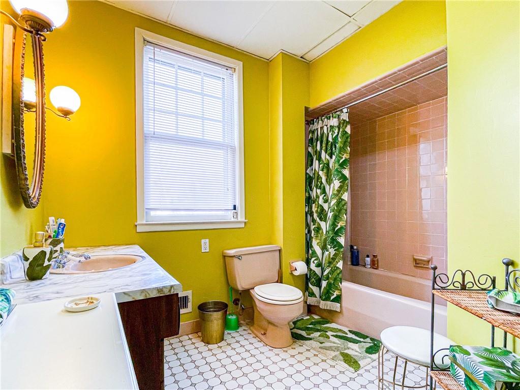 247 82nd Street Brooklyn, NY 11209 - Photo 32 of 48 a bathroom with a sink a toilet and shower