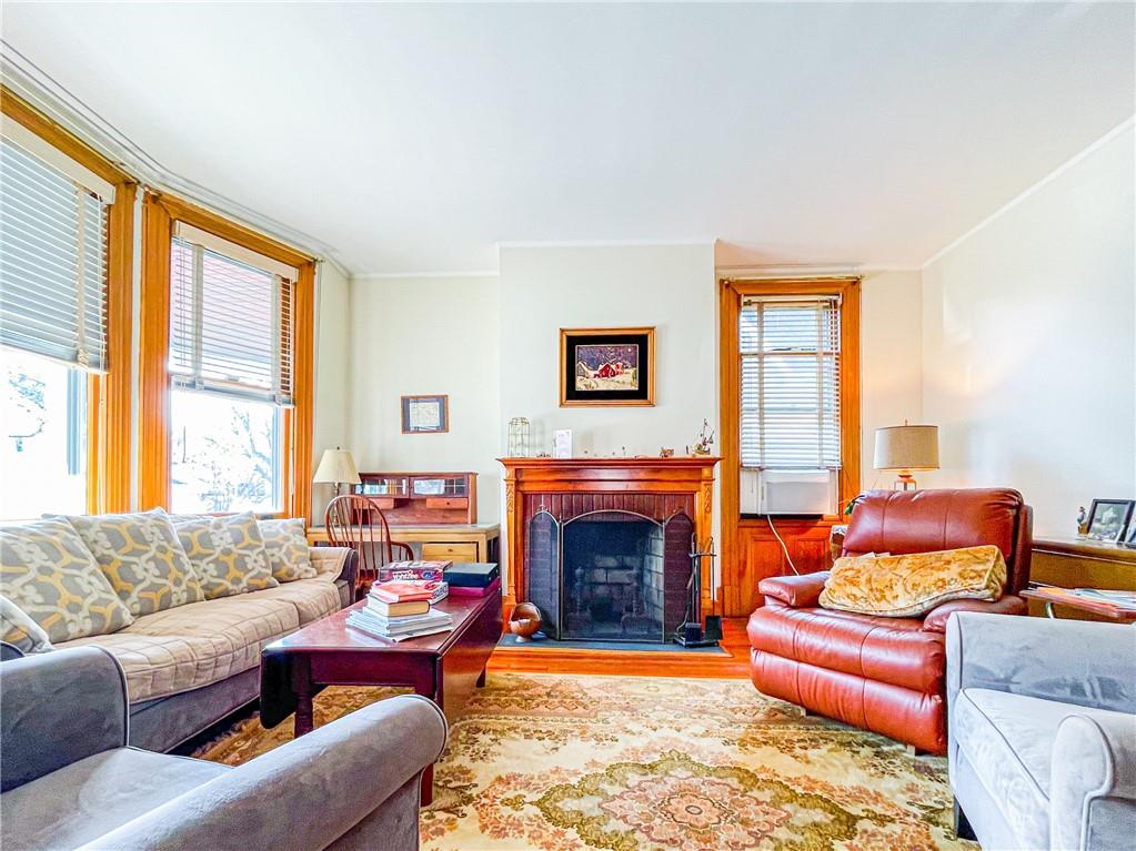 247 82nd Street Brooklyn, NY 11209 - Photo 4 of 48 a living room with furniture a fireplace and a large window