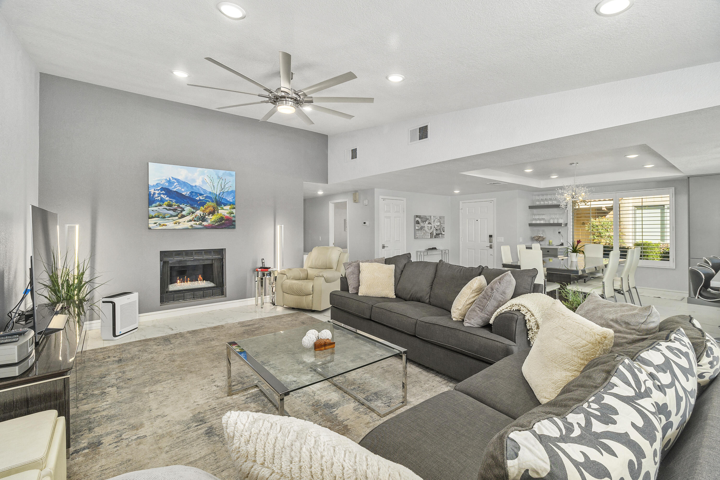 43 Conejo Circle Palm Desert, CA 92260 - Photo 11 of 58 a living room with furniture a fireplace and a chandelier