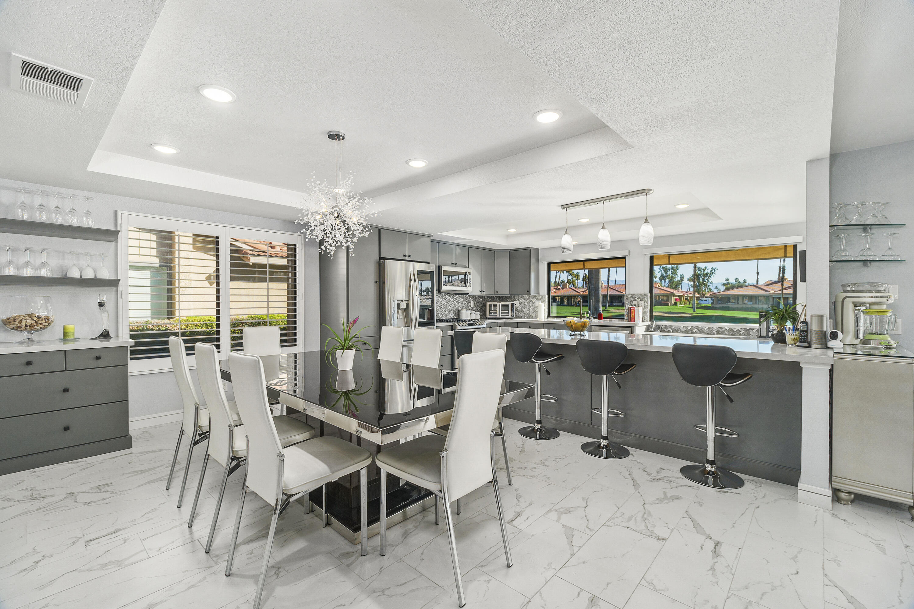 43 Conejo Circle Palm Desert, CA 92260 - Photo 12 of 58 a dining area with furniture and a floor to ceiling window