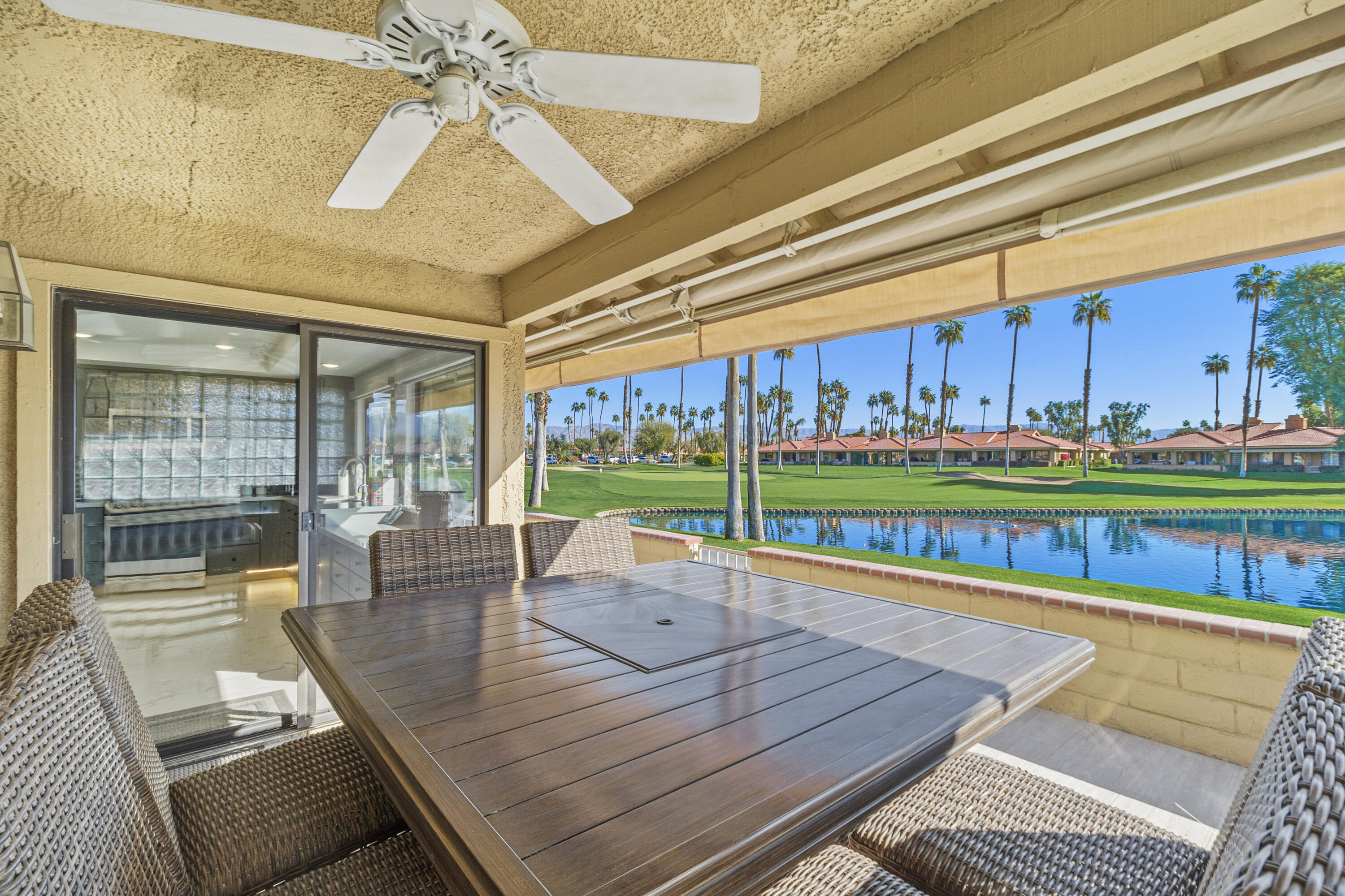 43 Conejo Circle Palm Desert, CA 92260 - Photo 2 of 58 a dining room with stainless steel appliances dining table furniture and a floor to ceiling window