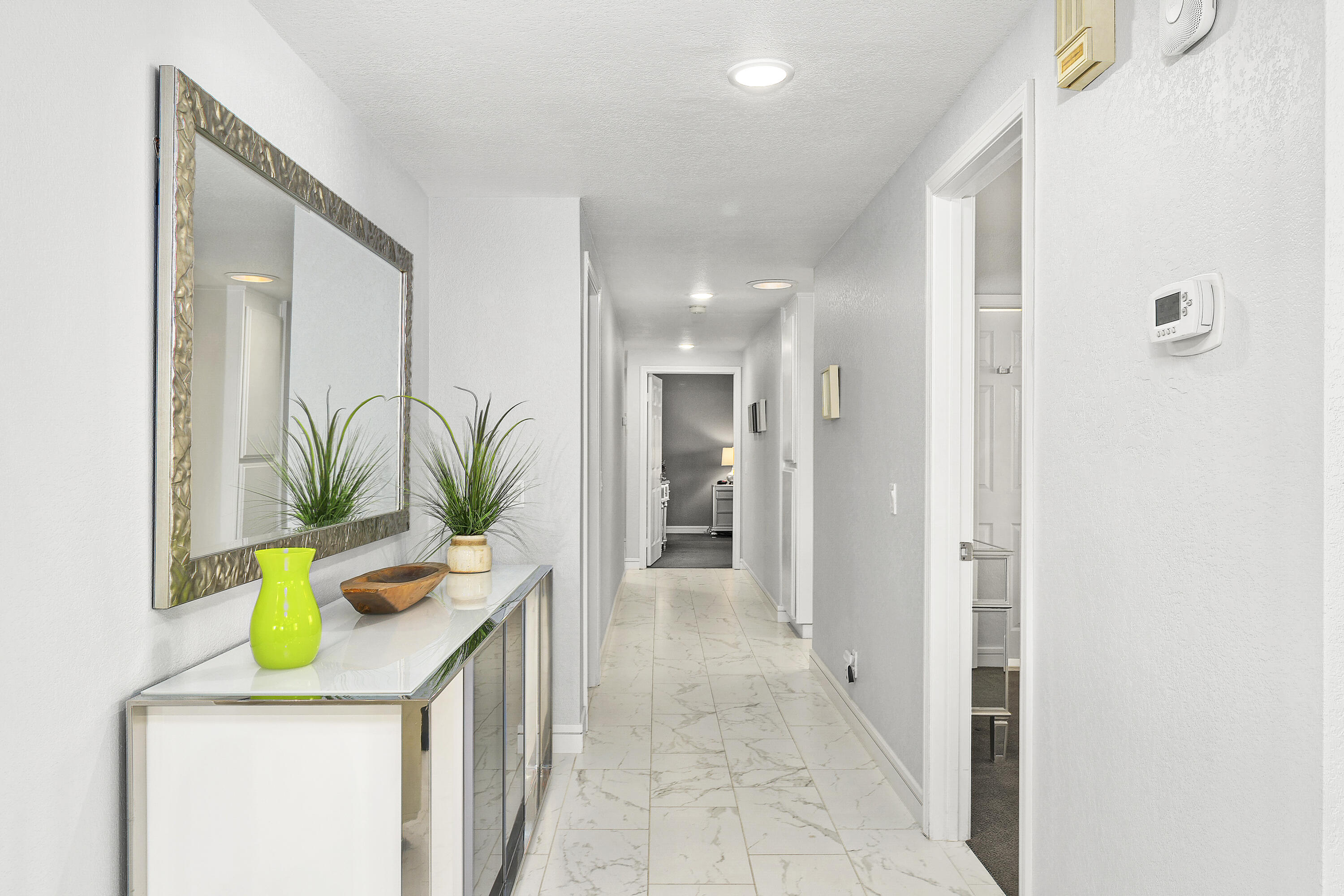 43 Conejo Circle Palm Desert, CA 92260 - Photo 22 of 58 a bathroom with a sink a mirror and a potted plant