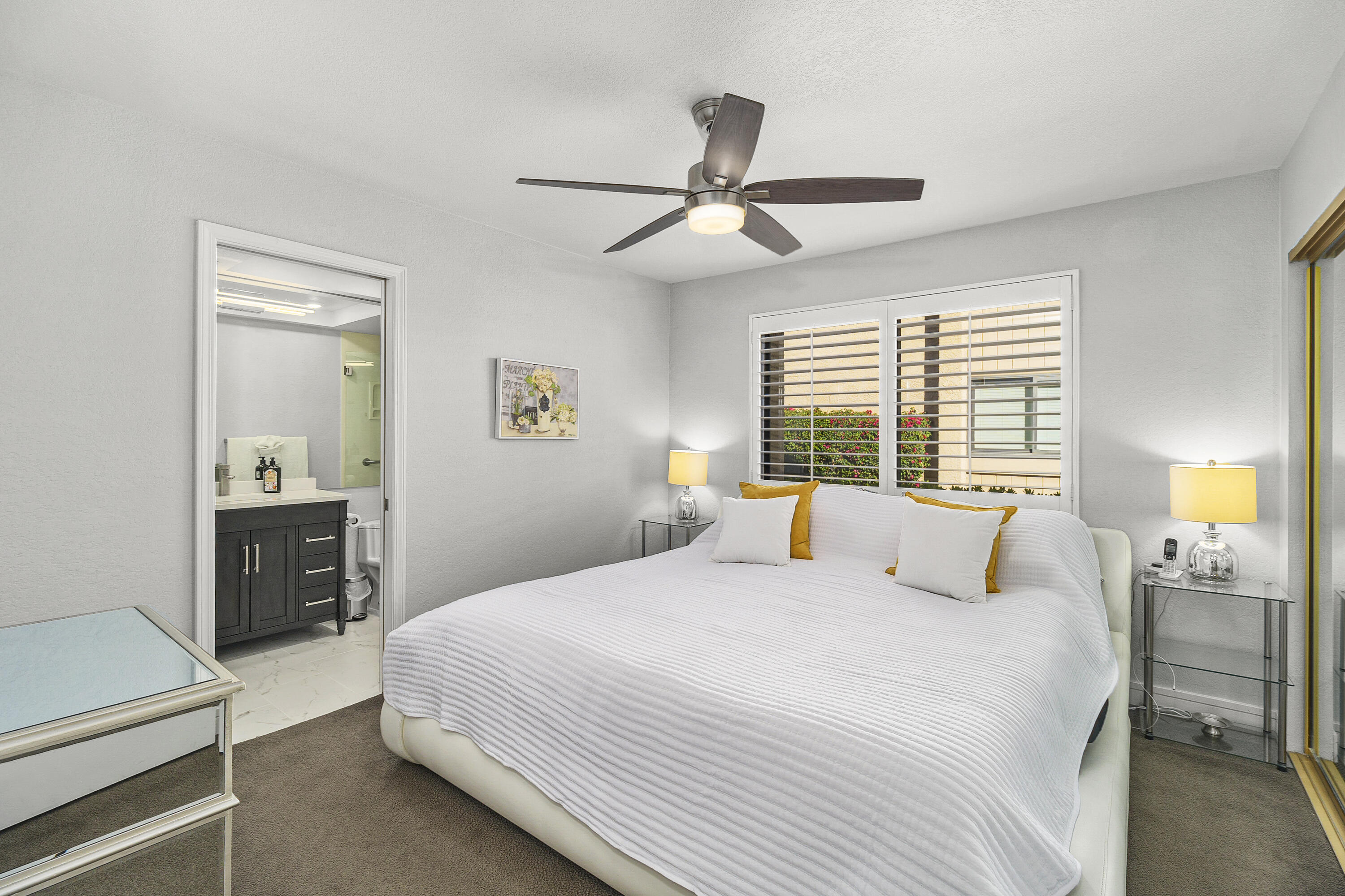 43 Conejo Circle Palm Desert, CA 92260 - Photo 23 of 58 a bedroom with a large bed and a window