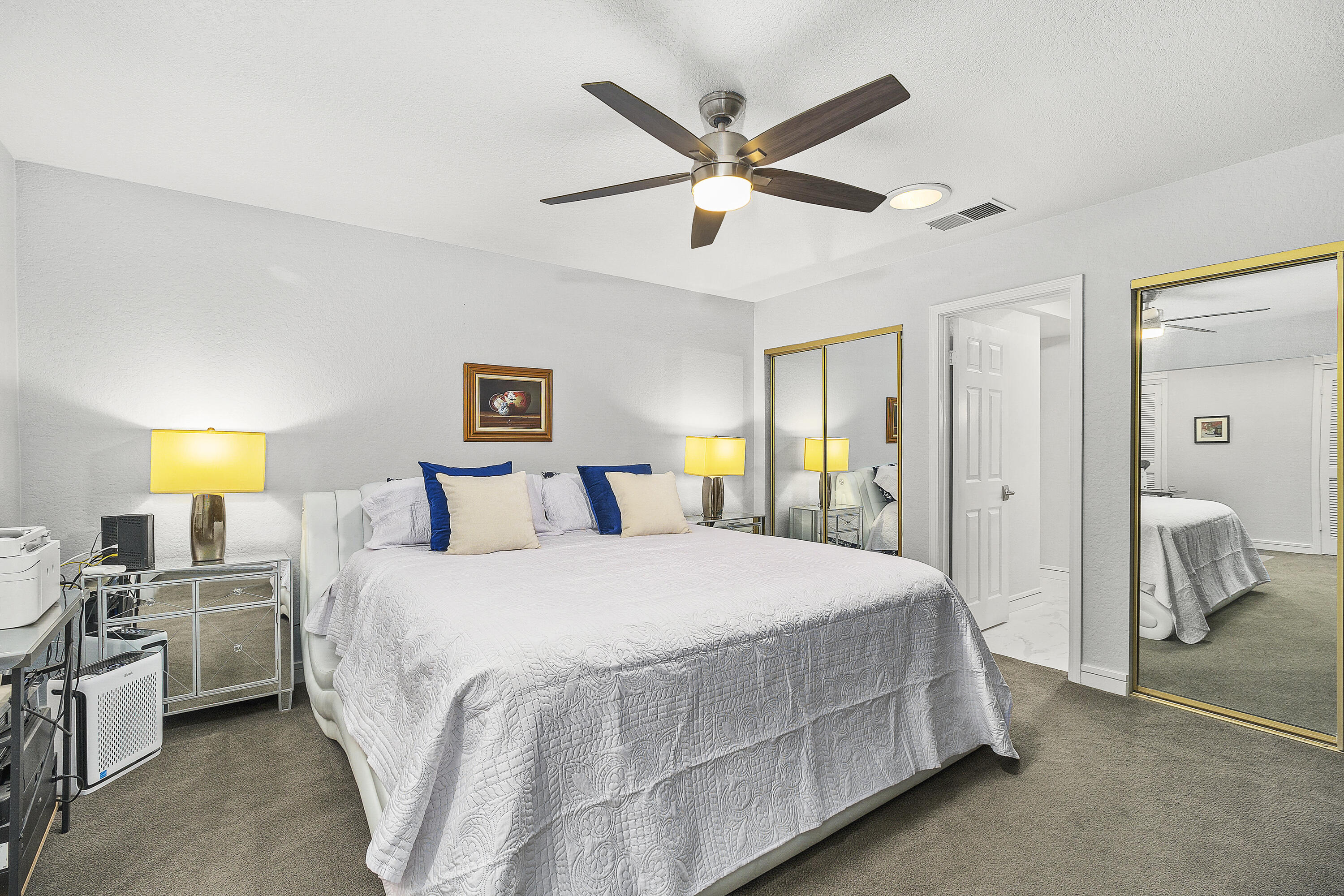 43 Conejo Circle Palm Desert, CA 92260 - Photo 26 of 58 a bedroom with a bed and a chandelier