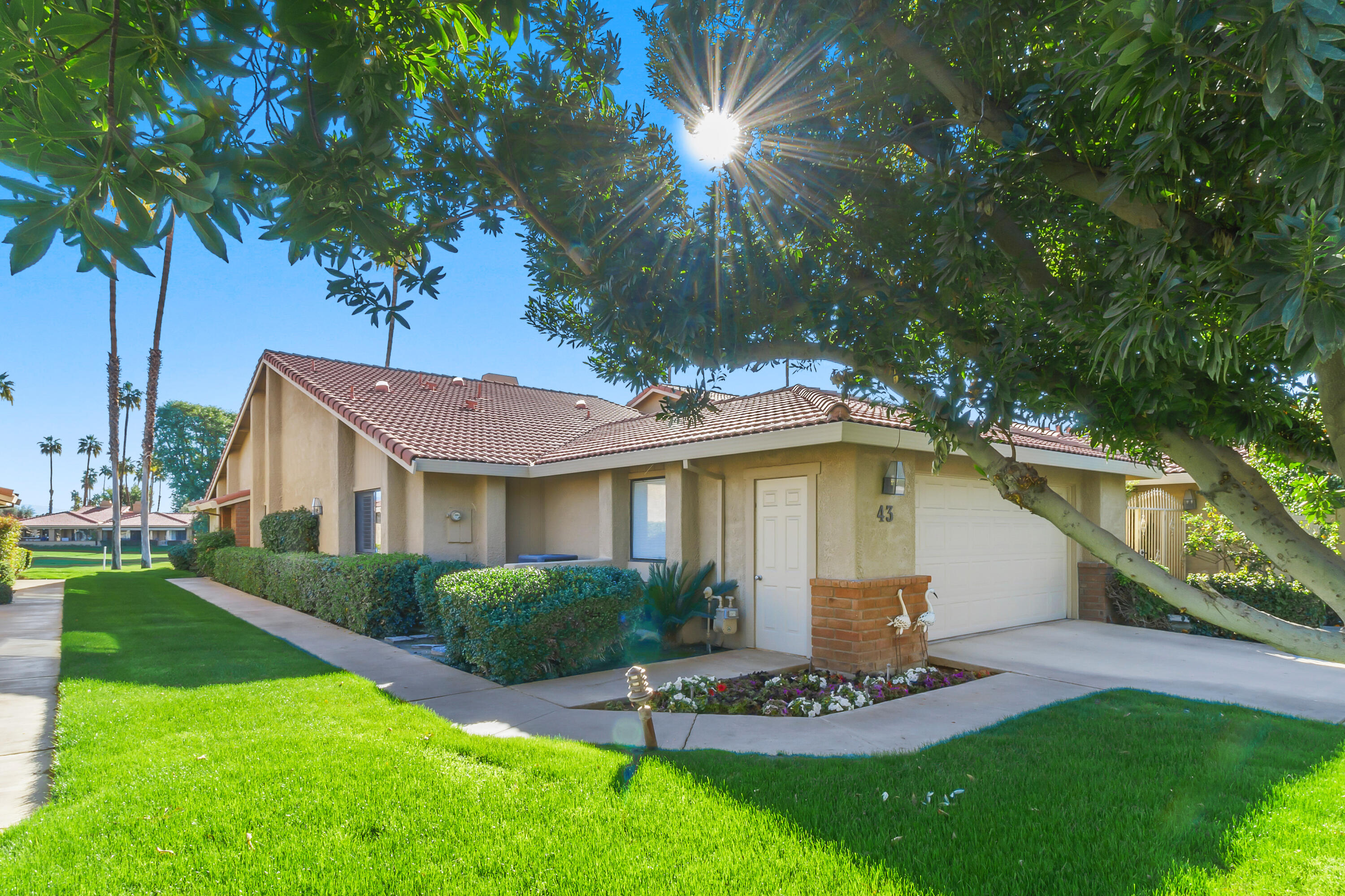 43 Conejo Circle Palm Desert, CA 92260 - Photo 33 of 58 a view of a house with a yard fire pit and a large tree