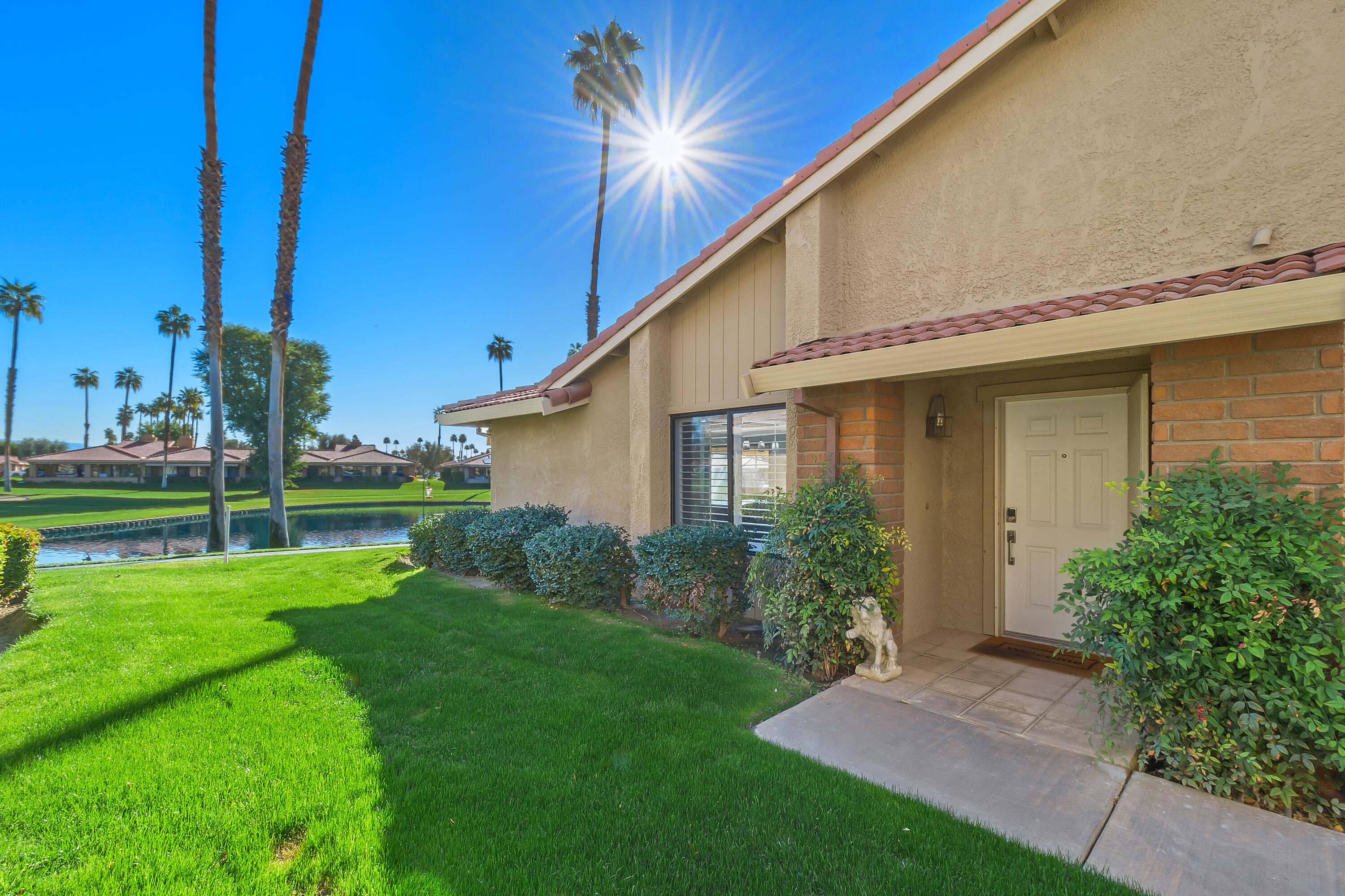 43 Conejo Circle Palm Desert, CA 92260 - Photo 34 of 58 a backyard of a house with plants and large tree