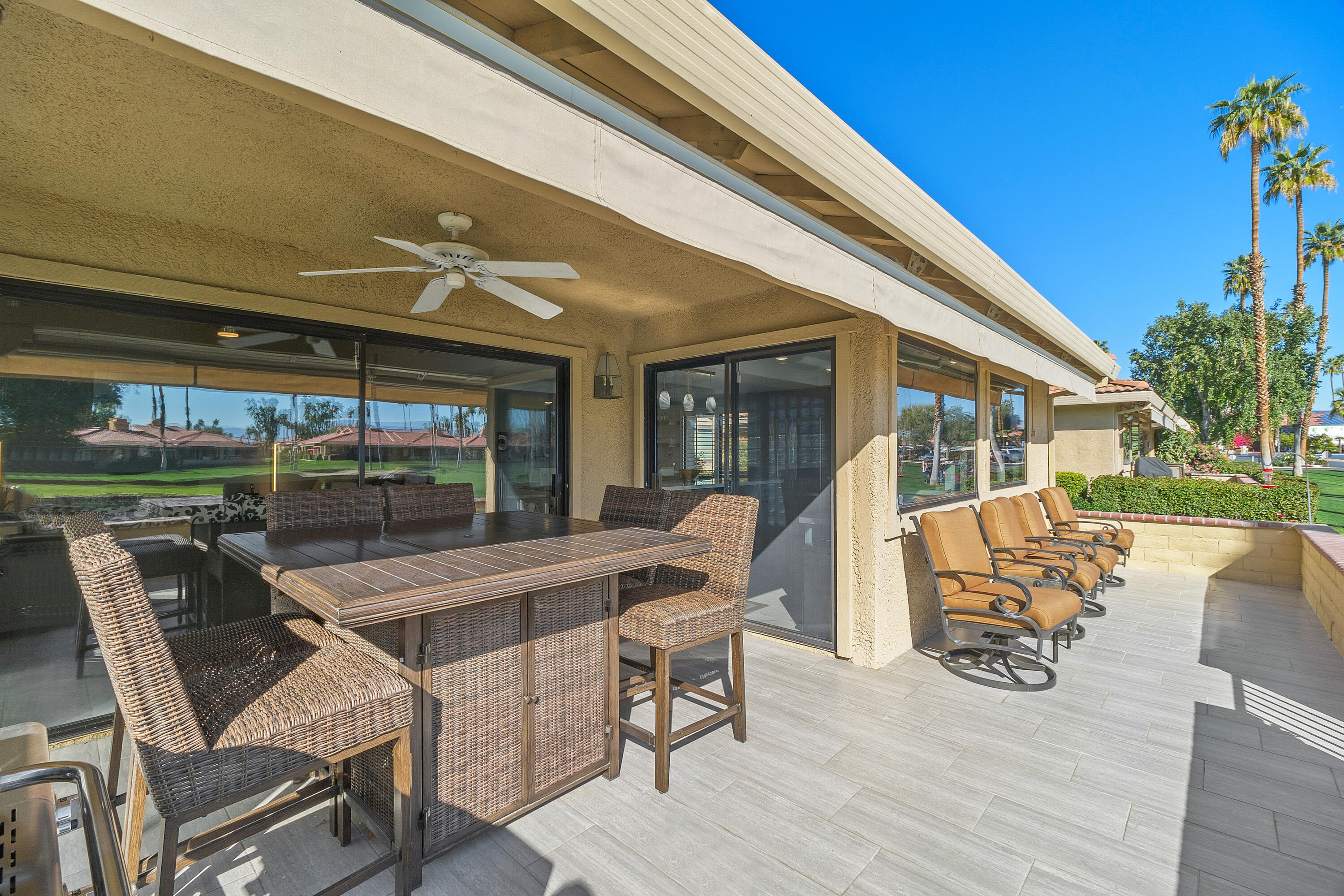 43 Conejo Circle Palm Desert, CA 92260 - Photo 35 of 58 a view of a patio with table and chairs with wooden floor and plants