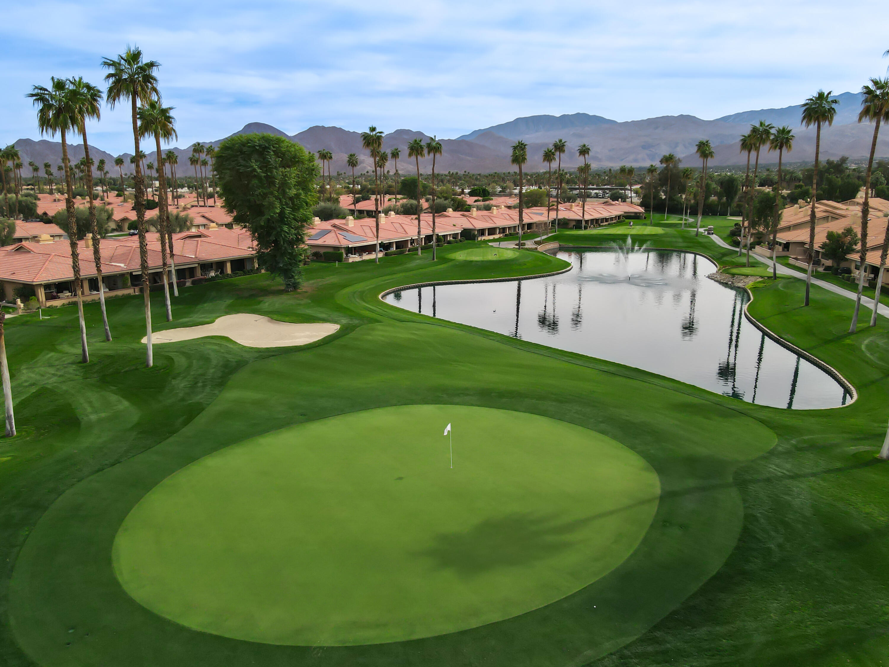 43 Conejo Circle Palm Desert, CA 92260 - Photo 38 of 58 a view of a swimming pool with a garden and trees