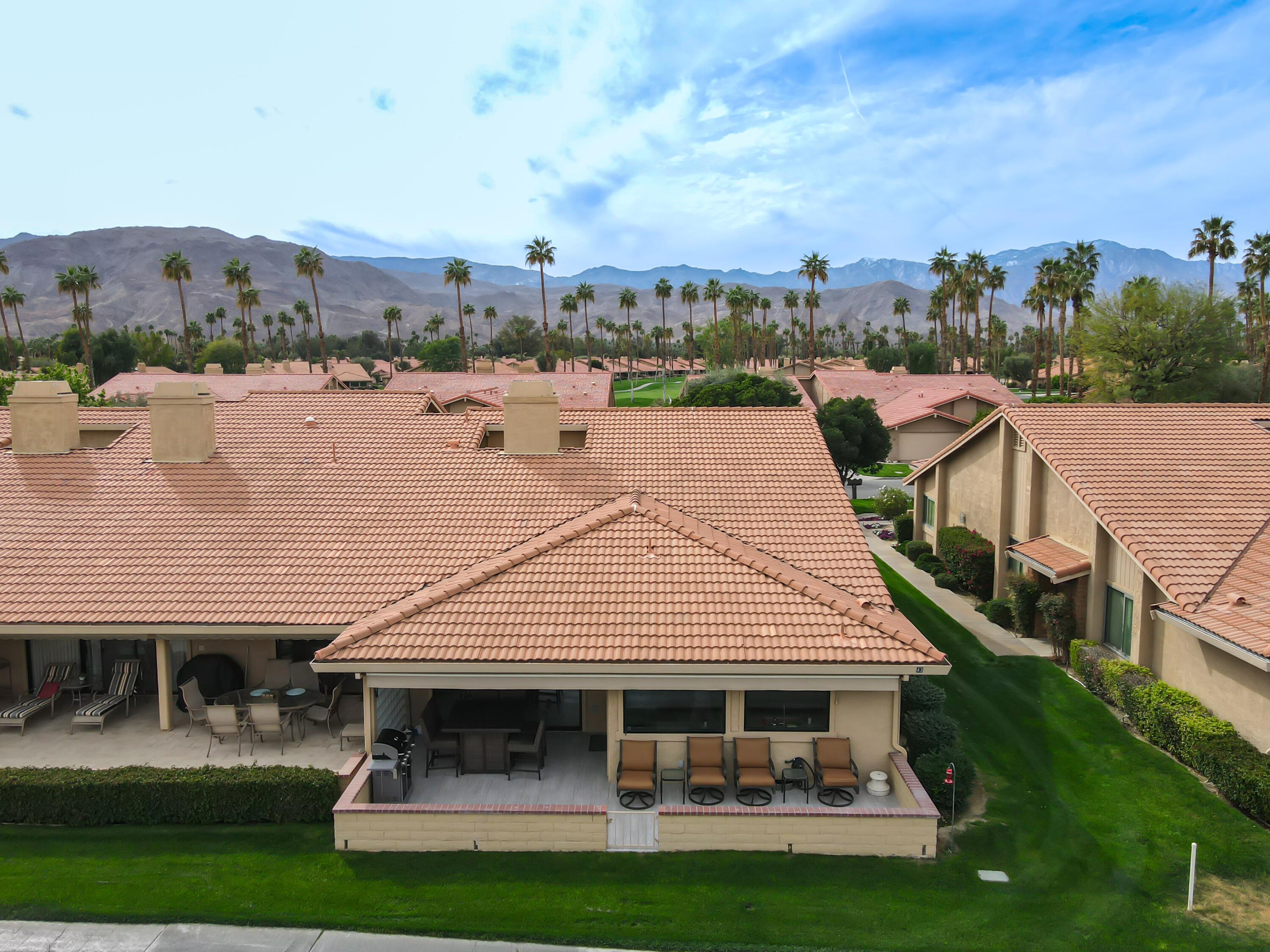 43 Conejo Circle Palm Desert, CA 92260 - Photo 40 of 58 a front view of a house with swimming pool and a chairs