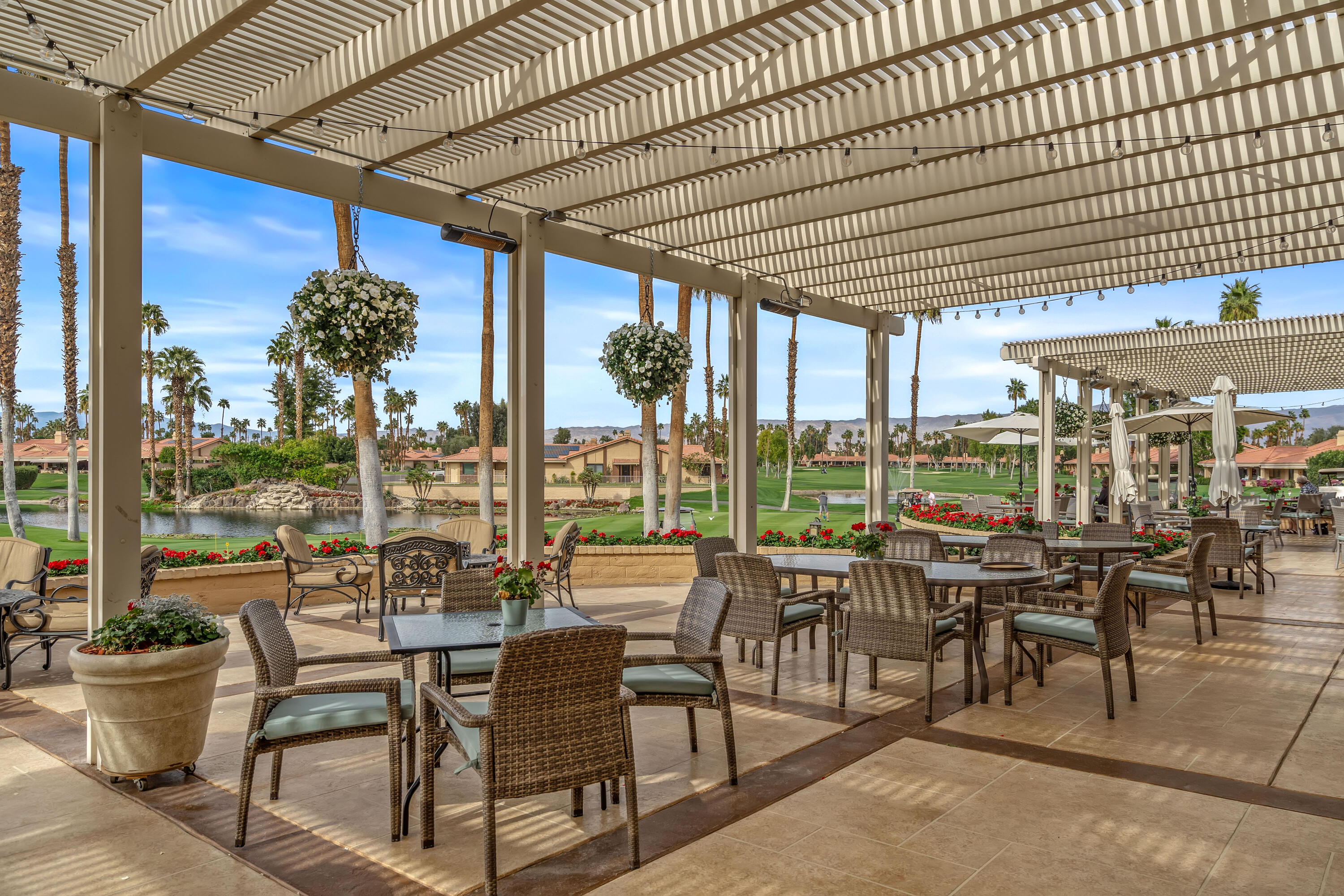 43 Conejo Circle Palm Desert, CA 92260 - Photo 53 of 58 a view of a patio with chairs and floor to ceiling window with plants