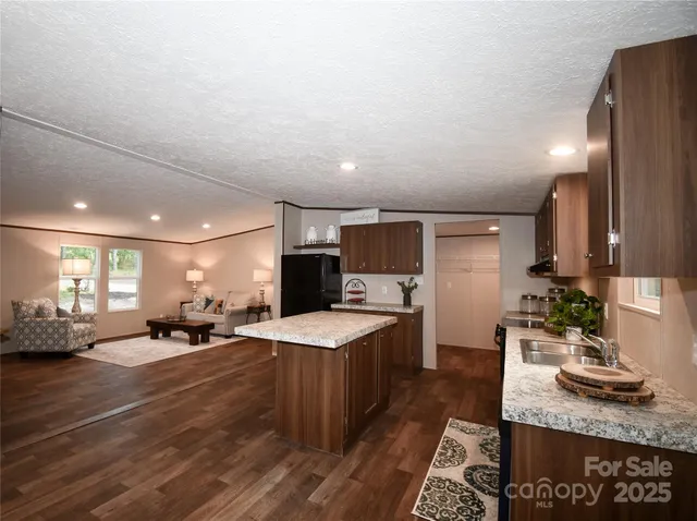 a large room with lots of counter space and windows