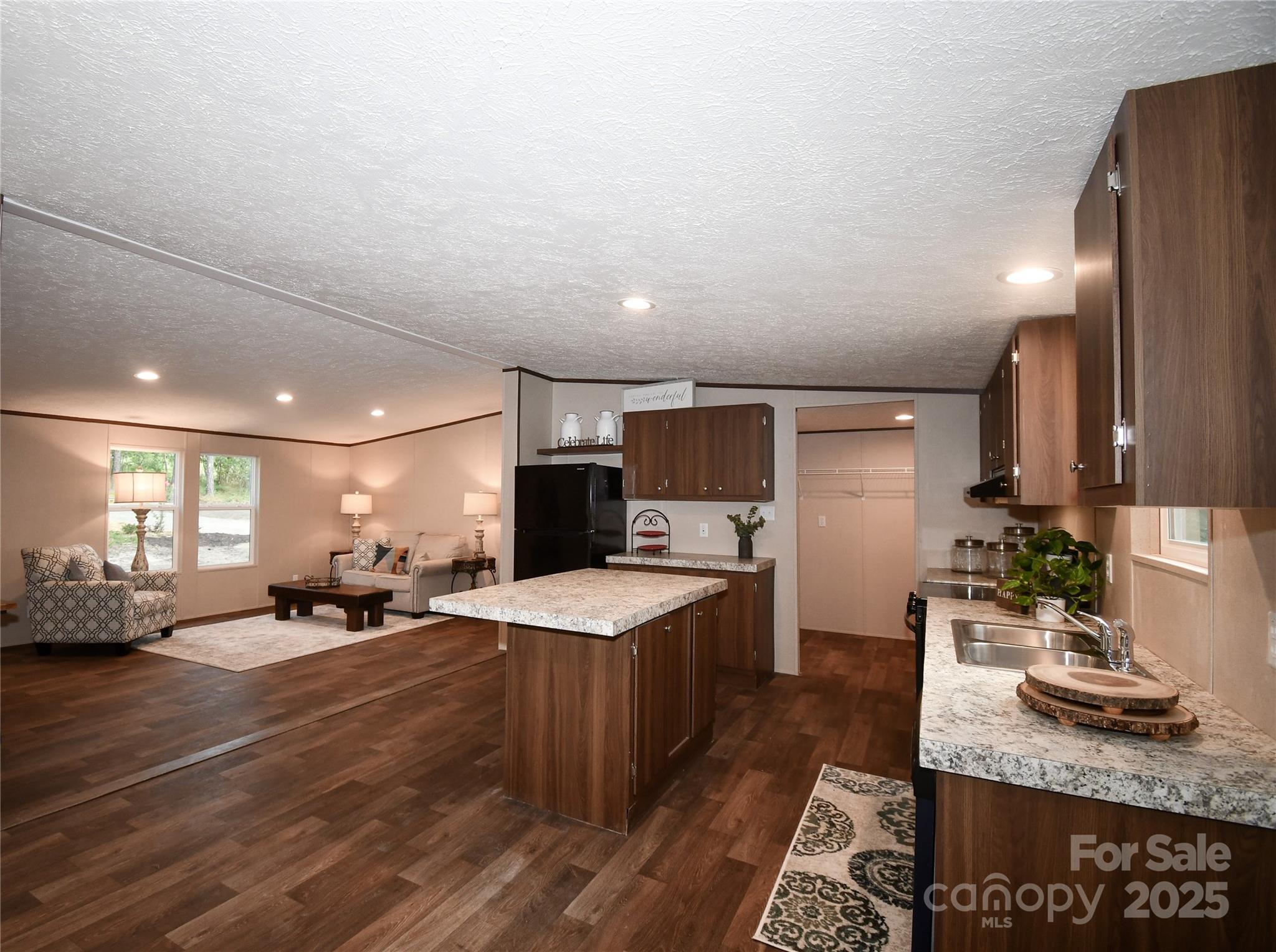 a large room with lots of counter space and windows