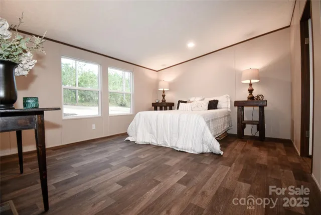 a bed room with a bed window and table