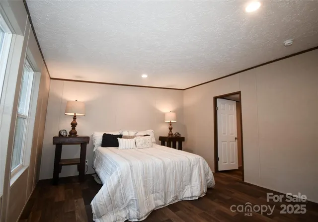 a bedroom with a bed and a mirror