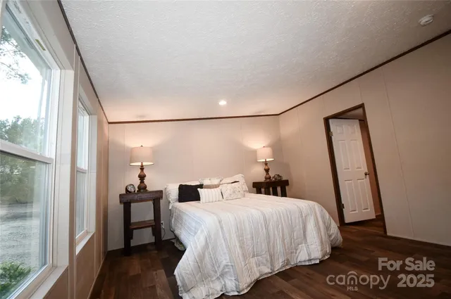 a bedroom with a bed and a mirror