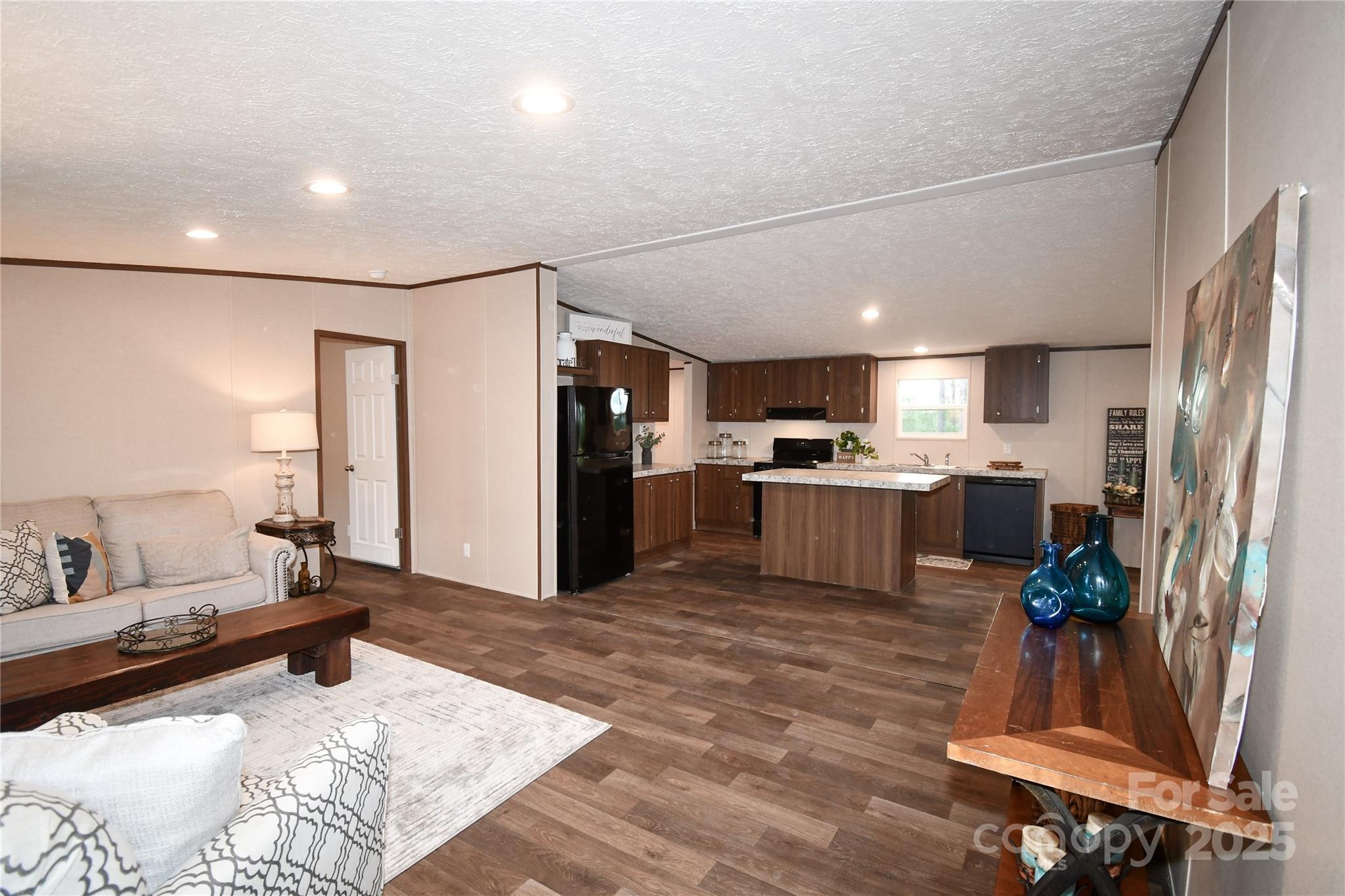 5339 Lockhart Road Kershaw, SC 29067 - Photo 8 of 28 a kitchen with stainless steel appliances kitchen island granite countertop a refrigerator and a sink