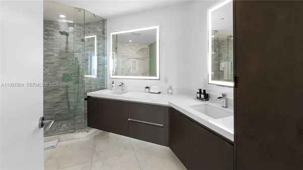 a bathroom with a sink double vanity and a mirror