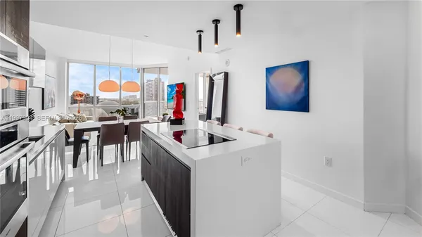 a kitchen with stainless steel appliances granite countertop a sink and a refrigerator