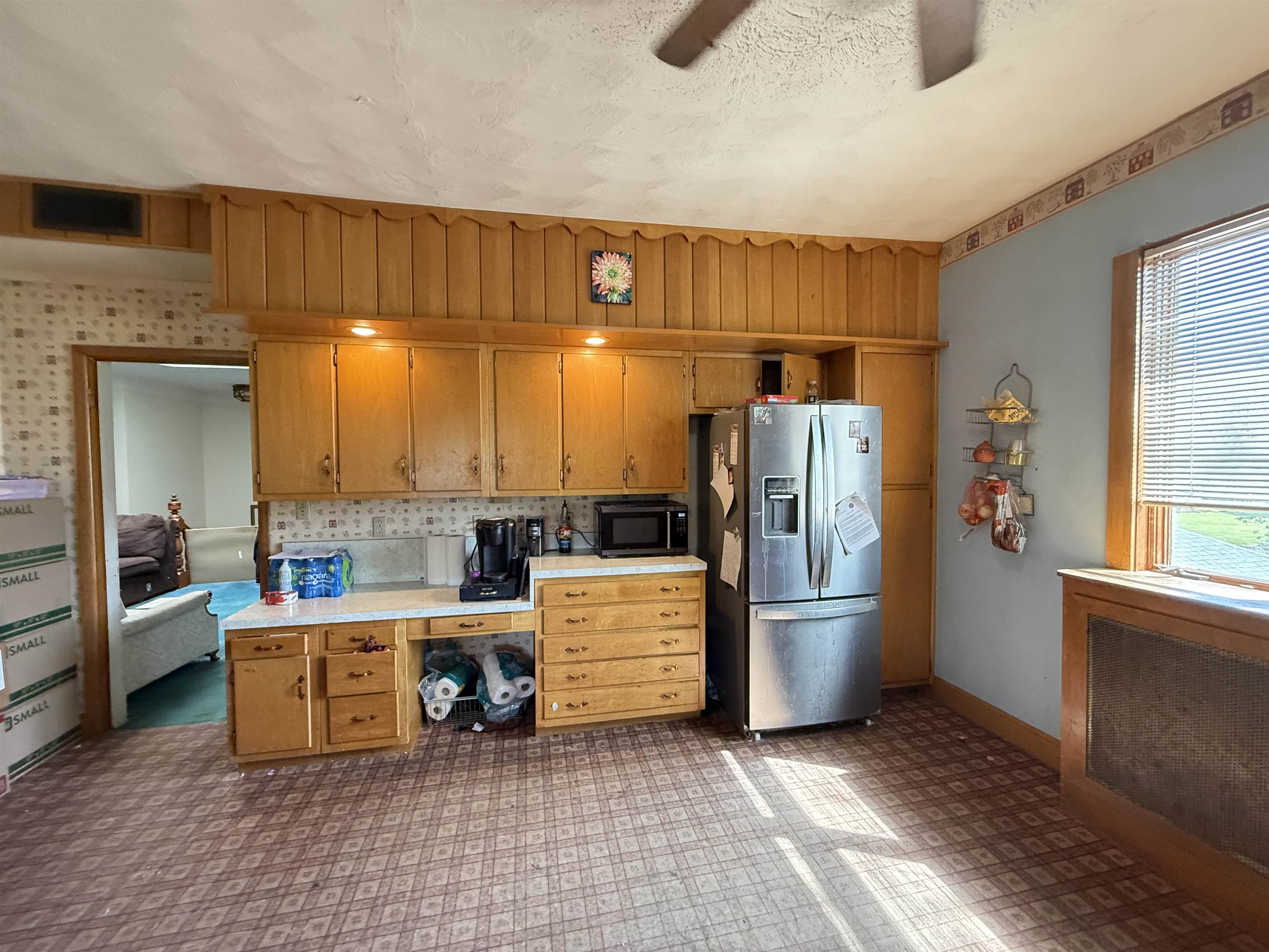323 South Main Street Stockton, IL 61085 - Photo 10 of 32 a kitchen with stainless steel appliances kitchen island granite countertop a refrigerator and stove
