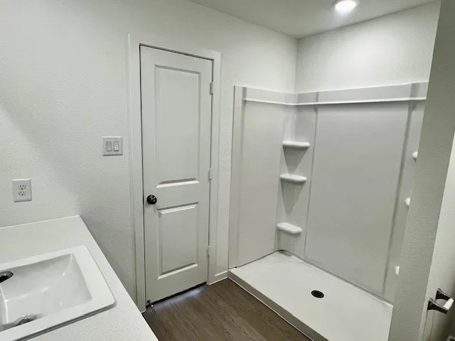 a bathroom with a tub and shower