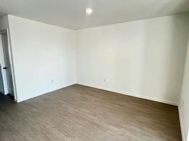 an empty room with wooden floor