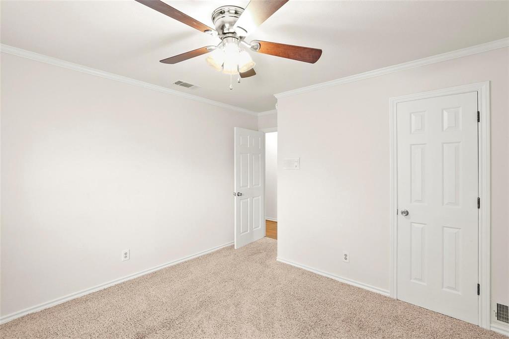 10135 Rita Road Dallas, TX 75243 - Photo 14 of 24 Unfurnished bedroom with crown molding, light carpet, and a ceiling fan