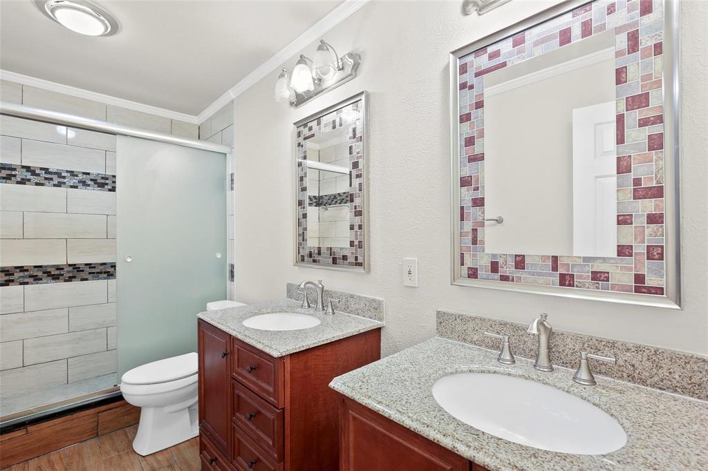 10135 Rita Road Dallas, TX 75243 - Photo 15 of 24 Full bath featuring crown molding, two vanities, a stall shower, and light wood-style flooring