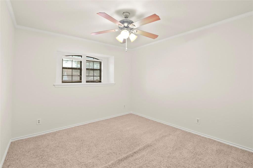 10135 Rita Road Dallas, TX 75243 - Photo 16 of 24 Spare room with carpet, ornamental molding, and a ceiling fan