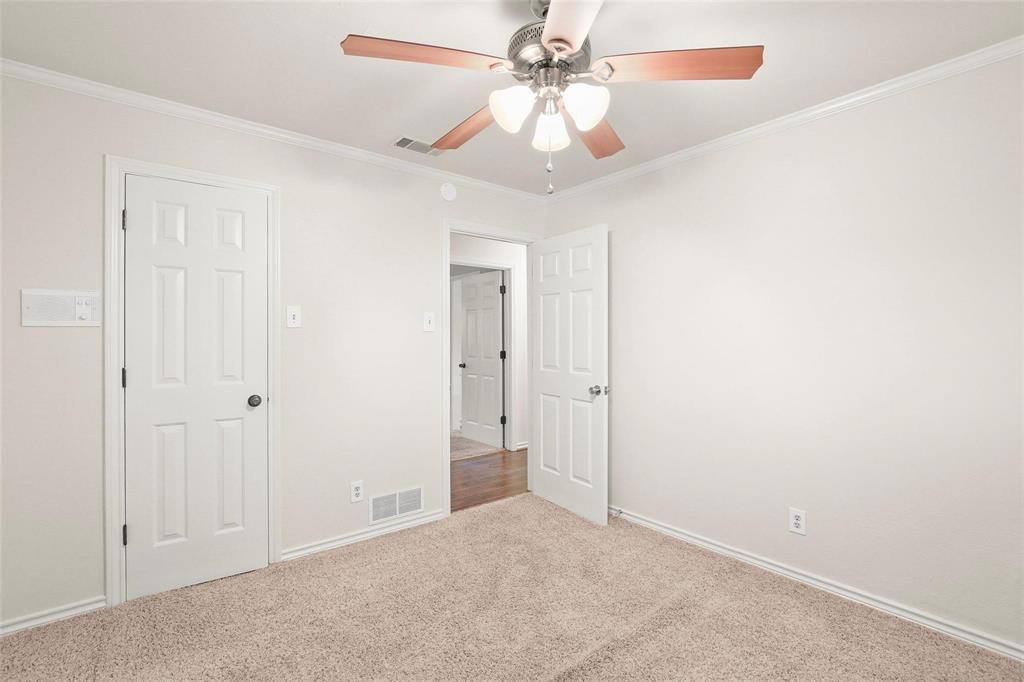 10135 Rita Road Dallas, TX 75243 - Photo 17 of 24 Unfurnished bedroom with crown molding, light carpet, and a ceiling fan