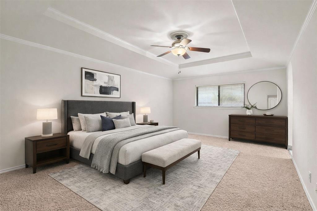 10135 Rita Road Dallas, TX 75243 - Photo 18 of 24 Bedroom with light carpet, a ceiling fan, crown molding, and a tray ceiling