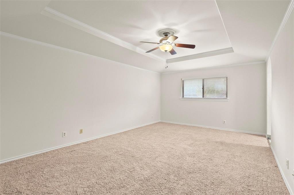 10135 Rita Road Dallas, TX 75243 - Photo 19 of 24 Unfurnished room with carpet, ceiling fan, ornamental molding, and a raised ceiling