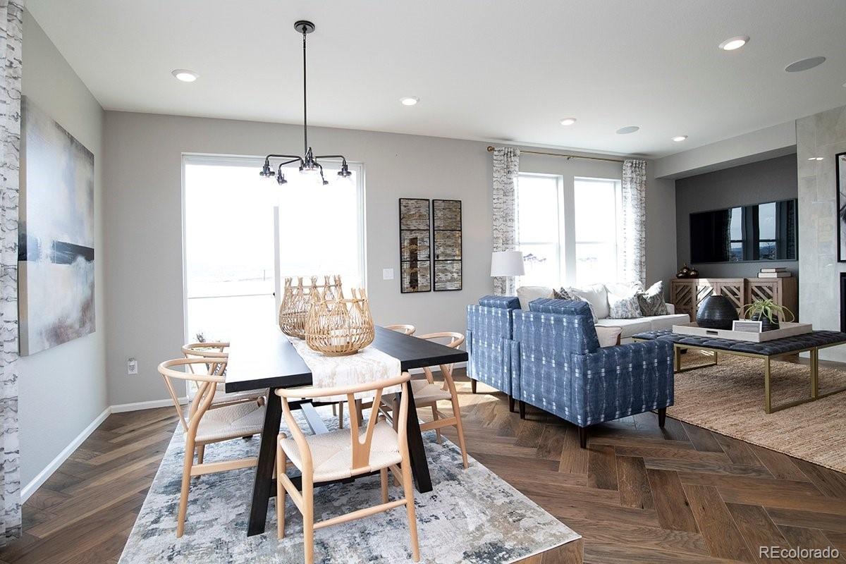 2199 Barela Drive Berthoud, CO 80513 - Photo 12 of 32 a view of a dining room with furniture window and wooden floor