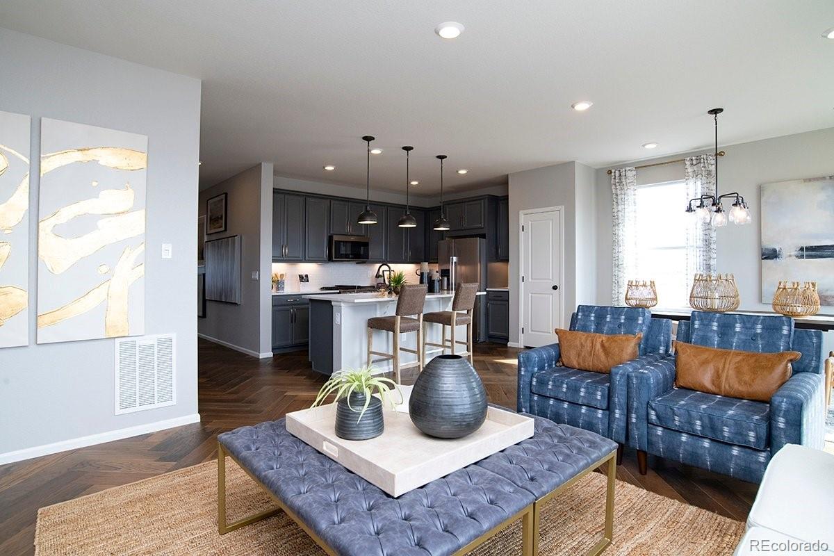 2199 Barela Drive Berthoud, CO 80513 - Photo 16 of 32 a kitchen with stainless steel appliances granite countertop a refrigerator and couch