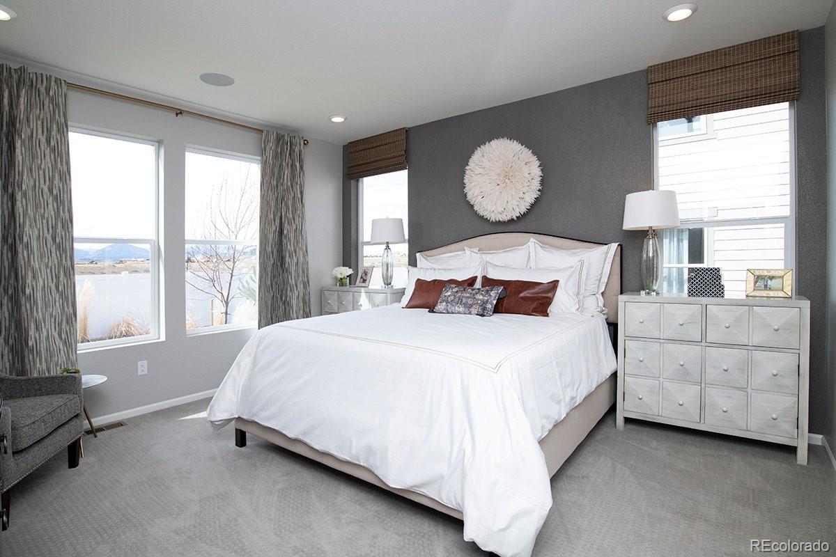 2199 Barela Drive Berthoud, CO 80513 - Photo 17 of 32 a bedroom with bed and a large window