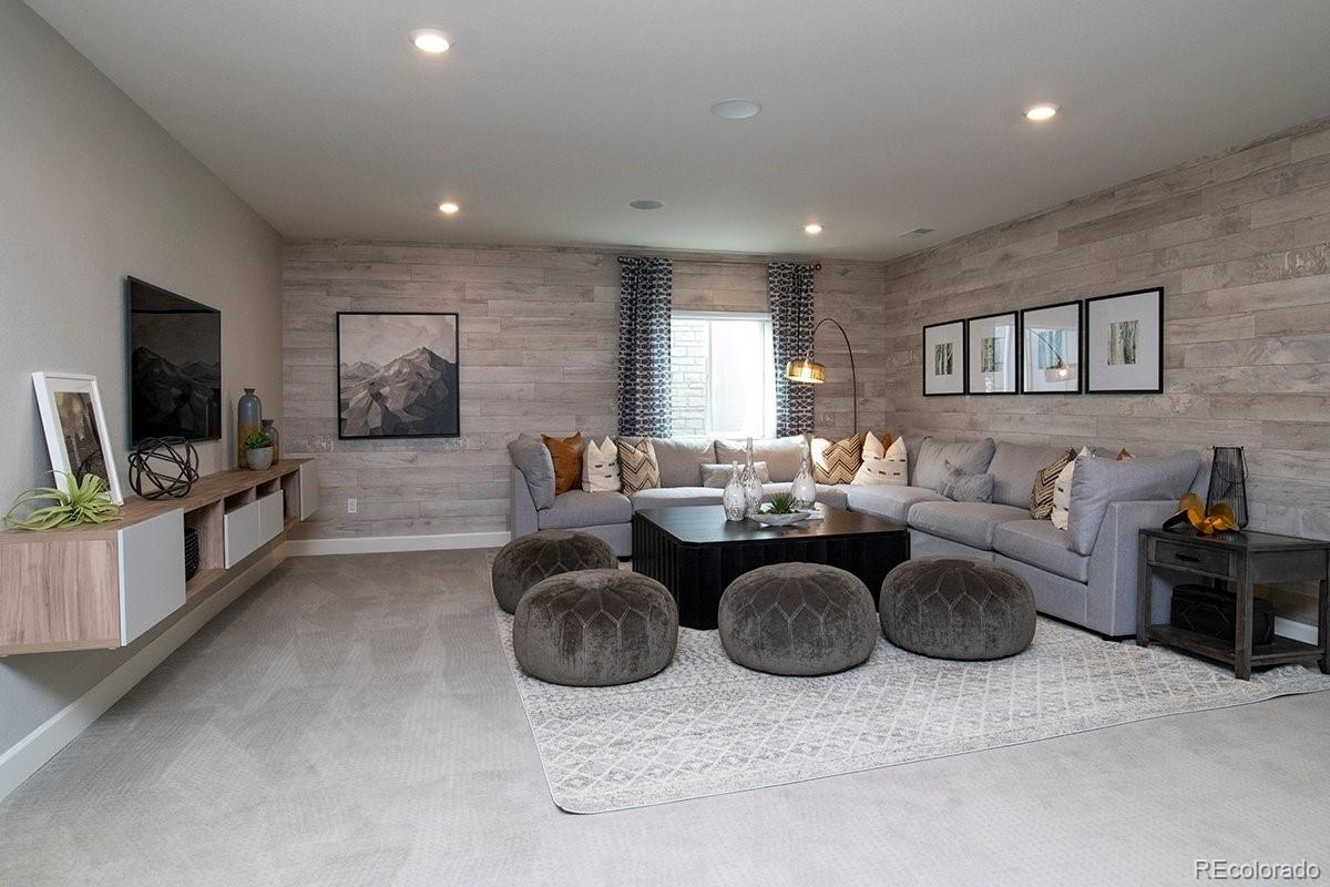 2199 Barela Drive Berthoud, CO 80513 - Photo 27 of 32 a living room with furniture a flat screen tv and a refrigerator